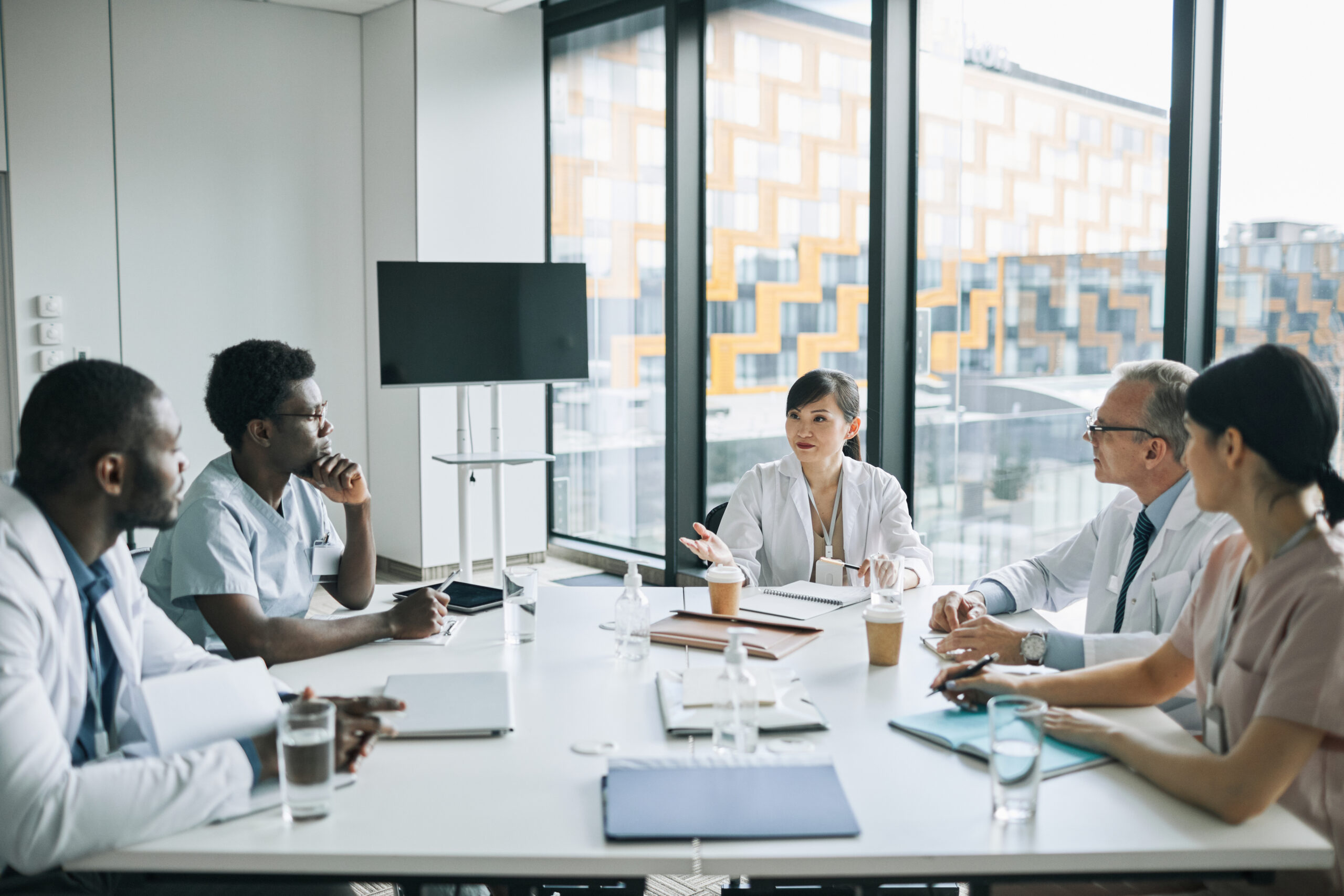Group of diverse health care professionals meeting at a table